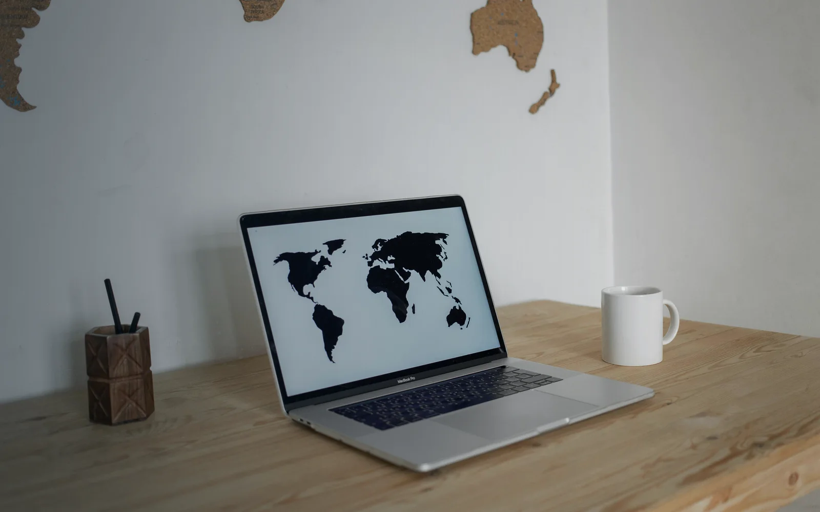 Laptop showing a world map for expat medical cover